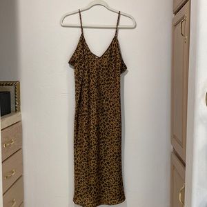 Never worn, but tags gone. Leopard print slip dress, matte satin. Knee length